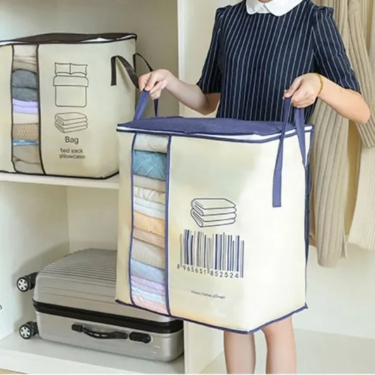 A woman holding a large, portable storage bag with a barcode design, filled with neatly stacked clothes. Another similar storage bag is placed on a shelf behind her.